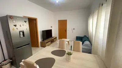 a kitchen with a table and a refrigerator at Quick Stay in Praia #2 in Praia