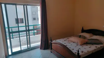 a bedroom with a bed and a large window at Casa de Gá in Mindelo