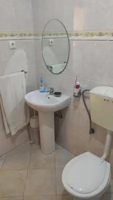 a bathroom with a sink and a toilet and a mirror at Casa de Gá in Mindelo