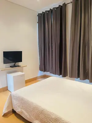 a bedroom with a bed and a flat screen tv at KAZARÃO DI MAVETE- Guesthouse in Praia