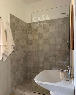 a bathroom with a bath tub and a sink at Residencial Casa Ângela in Espargos