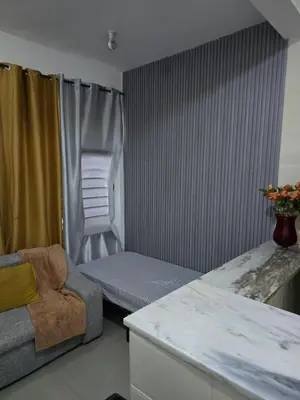 a living room with a couch and a chair at My Flat 1 in Praia