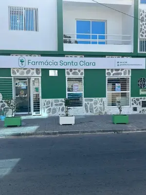 a green and white building with plants in front of it at My Flat 1 in Praia