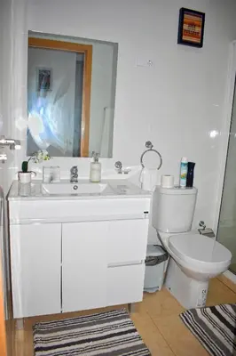a bathroom with a white sink and a toilet at Taninho in Santa Maria