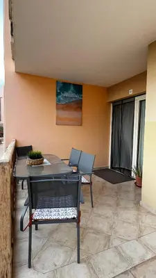 a patio with a table and chairs on a balcony at Tropical Morabeza Apartment Santa Maria in Santa Maria