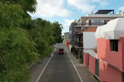 a street in a city with a car on the road at Hotel Viajante in Tarrafal