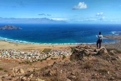a person standing on a hill looking at the ocean at Beach house kasa Sala mansa in Salamansa