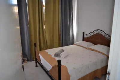 a bedroom with a bed and a window at Plateau Apartment in Praia