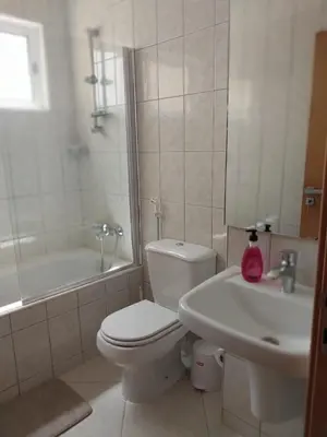 a white bathroom with a toilet and a sink at Solaren Apartments Boavista in Sal Rei
