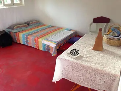 a bedroom with two beds and a red floor at Kasa di Terra in Sacramento