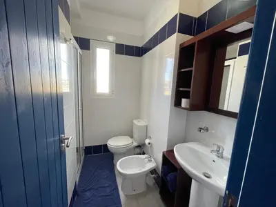a bathroom with a toilet and a sink at Casa Branca Beach in Santa Maria