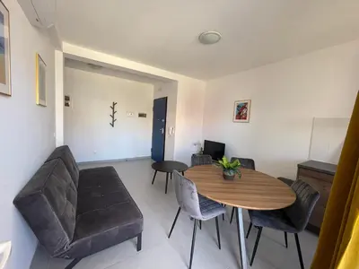 a living room with a dining room table and chairs at Casa Branca Beach in Santa Maria