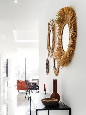 a living room with a table and mirrors on the wall at Filomena Apartments BOHÈME in Mindelo