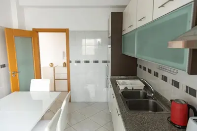 a kitchen with a sink and a counter top at 3 bedroom apt, Exterior POOL , Cidadela - LCGR in Praia