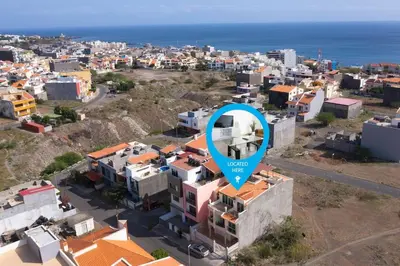 a blue sign on top of a building with a city at 3 bedroom apt, FREE WIFI & AC, Cidadela - LCGR in Praia