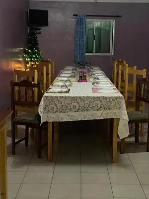 a dining room table with chairs and a christmas tree at Casa Ze & sonia in Portela
