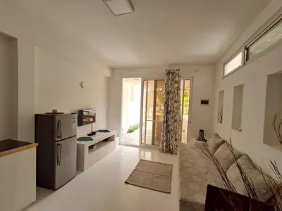a large living room with a refrigerator and a kitchen at Praia de Chaves Bungalow ,Boavista in Sal Rei