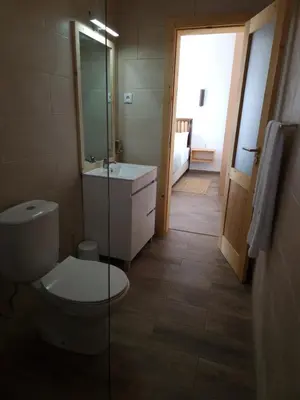 a bathroom with a toilet and a sink and a mirror at RM Green Hotel in Lombo Branco