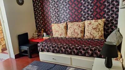 a bedroom with a bed and a red table at Casa de Férias in Tarrafal