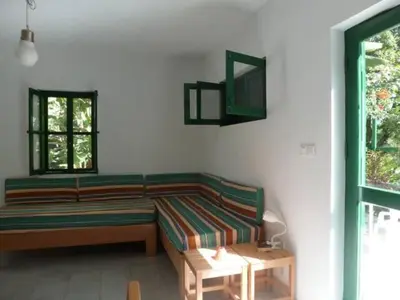 a living room with a couch and a table at Cottage na Ribeira do Paúl in Pombas