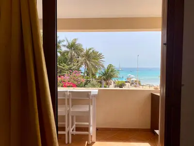 a room with a window with a view of the beach at Porto Antigo 2 - By Bobbywashere in Santa Maria