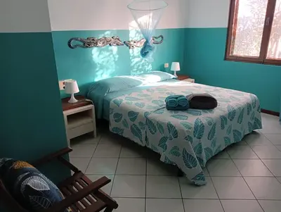 a bedroom with a bed in a blue room at Blu Shell - Ca' Greta in Sal Rei