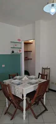 a dining room table with chairs and a white table cloth at Blu Shell - Ca' Greta in Sal Rei
