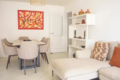 a living room with a couch and a table at 2 bdr cozy beachside apartment, Copacabana - LCGR in Mindelo