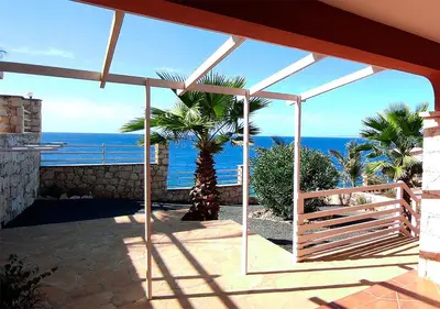a patio with a view of the ocean from a house at Villa Lagosta Stella Maris Exclusive in Vila do Maio