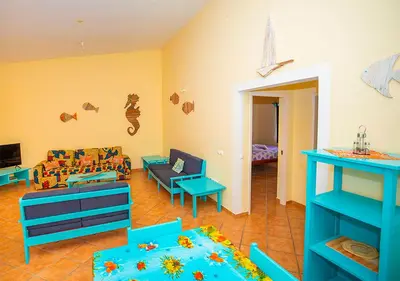 a living room with blue furniture and a couch at Villa Atum. Stella Maris Exclusive in Vila do Maio