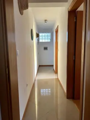 an empty hallway of a building with a window at Casa So Morabeza in Mindelo