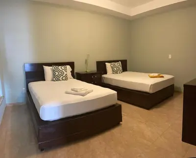 two beds in a room with two beds sidx sidx sidx at Spencer Residencial APARTAMENTOS in Praia