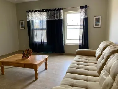 a living room with a couch and a coffee table at Spencer Residencial APARTAMENTOS in Praia