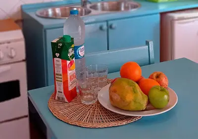 a table with a plate of fruit and a bottle of milk at Appartamento Buzio. Stella Maris Exclusive in Vila do Maio