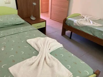 a bedroom with two beds with a blanket on them at Djadsal Moradias in Santa Maria
