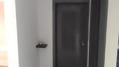 a black door in a room with a candle on it at Apartamentos Santiago - Tarrafal in Tarrafal