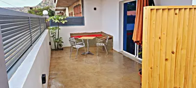 a small balcony with a table and chairs in a room at Apartamentos Santiago - Tarrafal in Tarrafal