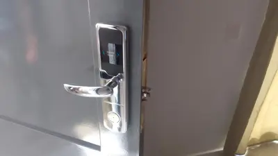 a metal door with a door knob on a bathroom door at Apartamentos Santiago - Tarrafal in Tarrafal