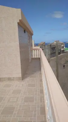a balcony of a house with a white railing at Kolina D´Sol in Ponta do Sol