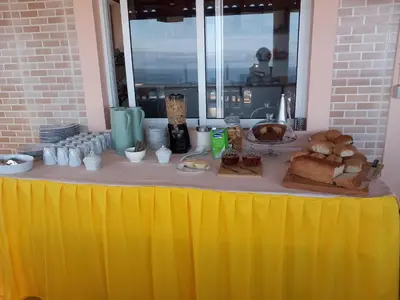 a yellow table with bread and other food on it at Kolina D´Sol in Ponta do Sol